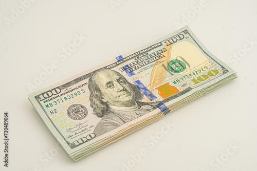 Dollars pack isolated on white background. Several 100 dollar bills are stacked up