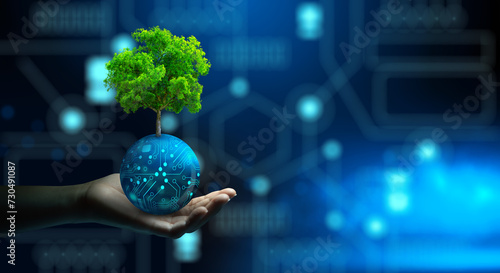 Man hand holding Tree on digital ball with technological convergence blue background. Green computing, csr, IT ethics, Nature technology interaction, and Environmental friendly. photo