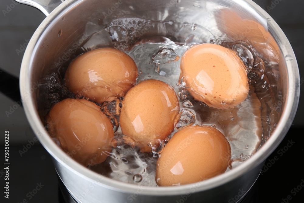 Chicken eggs boiling in saucepan on electric stove, closeup Chicken eggs boiling in saucepan on electric stove, closeup
