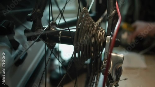 Close up: After adjusting shifters, bicycle chain spins rear sprocket photo