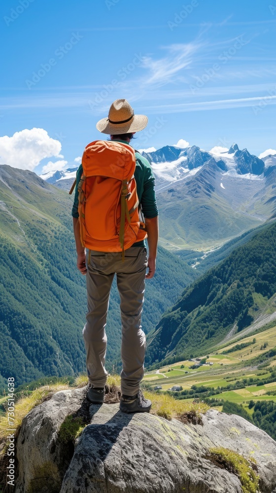 Adventurous Spirit: Hiker Overlooking Mountain Valley with Clear Blue Skies Hiker in hat, orange backpack, standing on rock, overlooking mountain valley, clear blue sky, green slopes, adventure