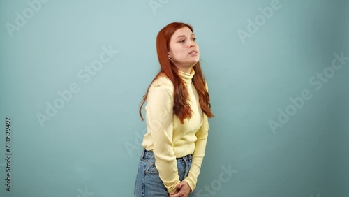 Caucasian woman in her 30s really need to pee and looking very worried in a studio photo
