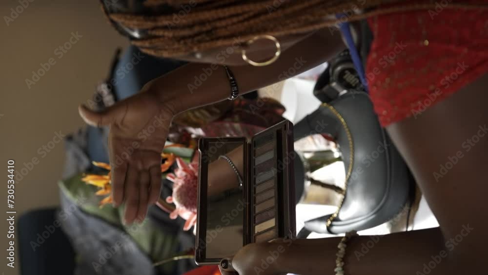 Ugandan Woman Applying her Makeup - Vertical Shot Ugandan Woman Applying her Makeup - Vertical Shot