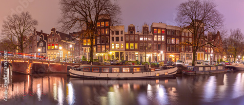 Panorama of typical houses and bridge at Amsterdam canal Brouwersgracht at night, Holland, Netherlands