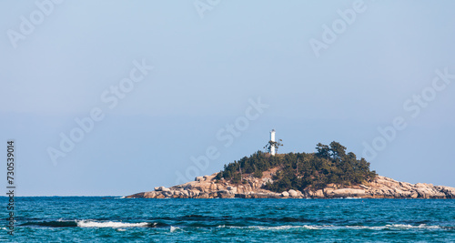 A beach lighthouse visible in the distance. sea ​​landscape © two K