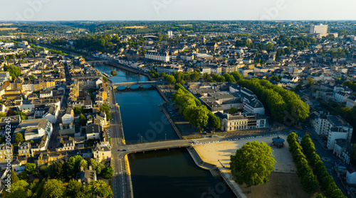 Aerial view of modern cityscape of French town of Laval on banks of Mayenne River in summertime