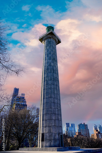 New York City Skyline and Dramatic Cloudscape at Fort Greene Park in Brooklyn, with the view of Prison Ship Martyrs' Monument standing tall over the bare winter trees and buildings