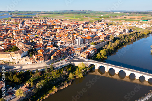 Scenic drone view of small ancient Spanish town of Tordesillas on banks of Duero river in province of Valladolid on sunny spring day.. photo