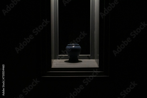 Abstract and still life style of blue jar in the wood frame with shadows and lightings. 
