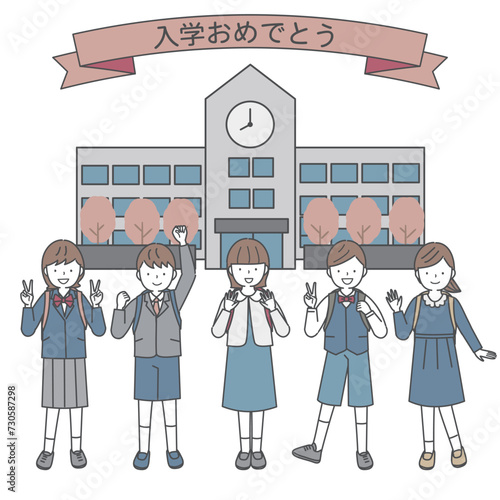 学校の前でランドセルを背負ってポーズをとる新入生