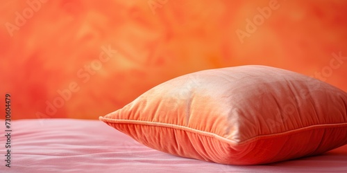 A pillow in the trendy color Peach Fuzz, set against a background with selective focus, providing ample copy space for additional content or text.