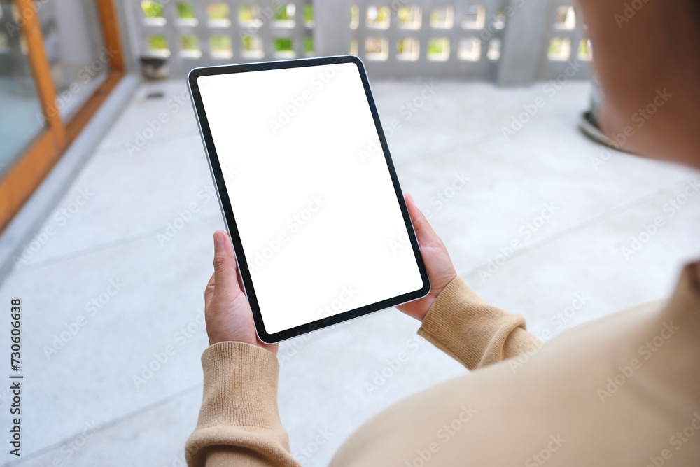 Mockup image of a woman holding digital tablet with blank white desktop screen Mockup image of a woman holding digital tablet with blank white desktop screen