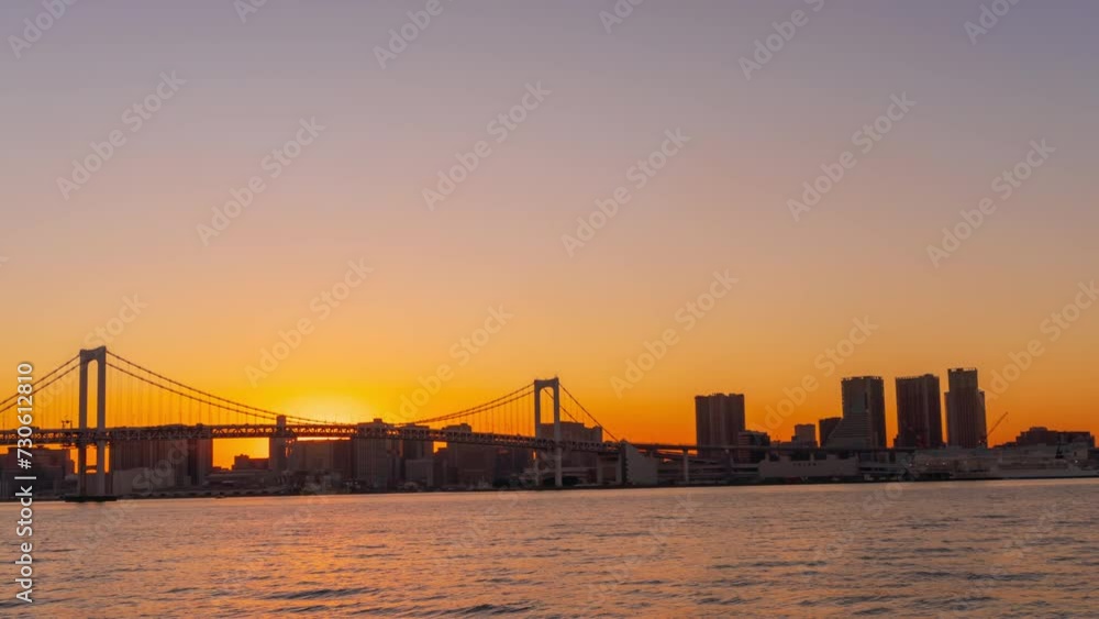 Time lapse of Tokyo bay with Rainbow Bridge, from sunset through to twilight shot Time lapse of Tokyo bay with Rainbow Bridge, from sunset through to twilight shot