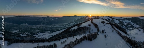 Sunset over the second Jura chain in winter, foreground contours of sinkholes, view towards the first Jura chain with Weissenstein, drone image, Brunnersberg, Solothurn, Switzerland, Europe