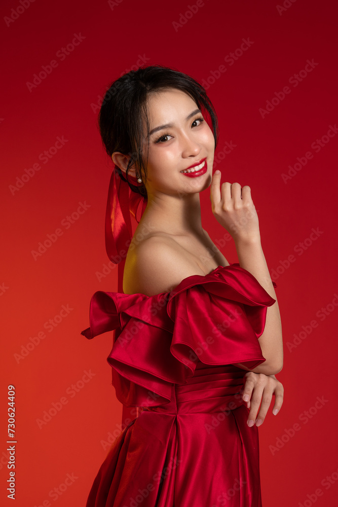 New Year atmosphere, an Asian young woman against a red background New Year atmosphere, an Asian young woman against a red background