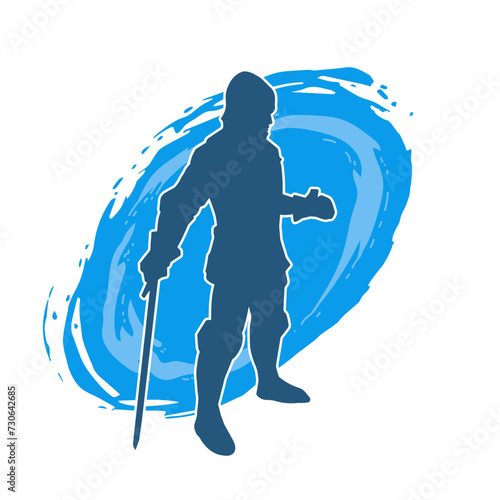Silhouette of a male warrior wearing war armor suit in action pose using a sword weapon.