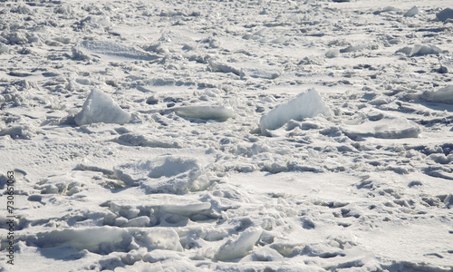 Winter landscape - frozen sea surface with snow.