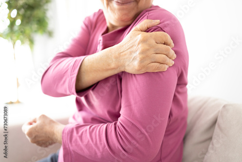 Senior woman suffers from shoulder joint pain, shoulder stiffness or osteoporosis