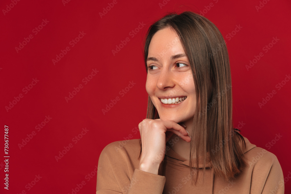 Close up studio portrait of a smiling woman holding hand under her chin. Close up studio portrait of a smiling woman holding hand under her chin.