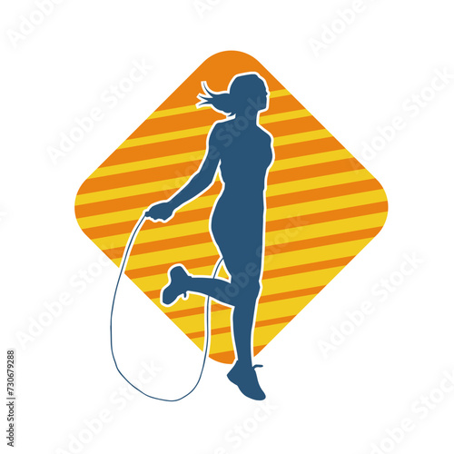 Silhouette of a slim sporty woman doing jump rope workout.