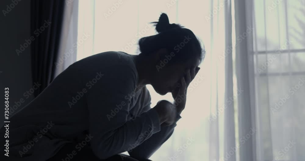 Atmosphere of depression, Trouble in relationship, death in the family. Sad young woman in the living room of her home, Covering face with hands. Dramatic bad news cinematic slow motion moment. Atmosphere of depression, Trouble in relationship, death in the family. Sad young woman in the living room of her home, Covering face with hands. Dramatic bad news cinematic slow motion moment.