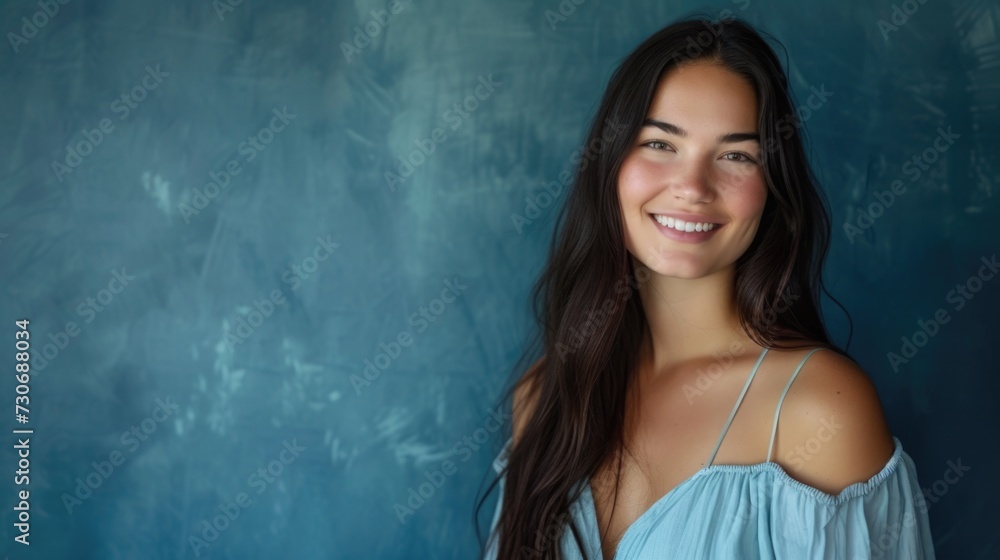 Casual Elegance: Young Woman's Carefree Smile on Sunny Day casual blue top, carefree expression, textured blue wall, natural beauty, sunny day, relaxed vibe. Casual Elegance: Young Woman's Carefree Smile on Sunny Day casual blue top, carefree expression, textured blue wall, natural beauty, sunny day, relaxed vibe.