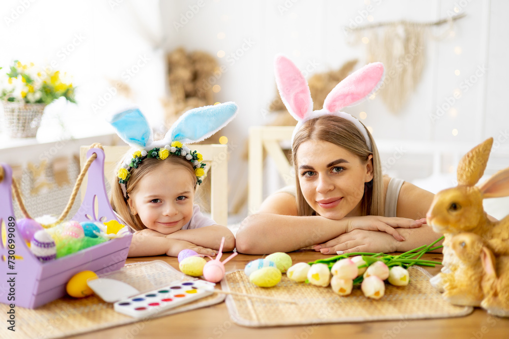 easter, mom and little daughter with bunny ears on their head are preparing for the holiday by having fun playing and spending time together, colorful eggs, lifestyle, easter, mom and little daughter with bunny ears on their head are preparing for the holiday by having fun playing and spending time together, colorful eggs, lifestyle,