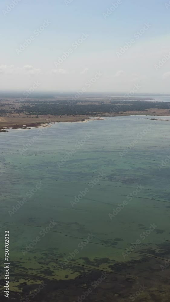 The coast of a tropical island and a shallow sea against the sky and clouds. Jaffna, Sri Lanka. The coast of a tropical island and a shallow sea against the sky and clouds. Jaffna, Sri Lanka.