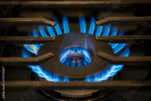 Natural gas burner on stove. High heat, close-up.