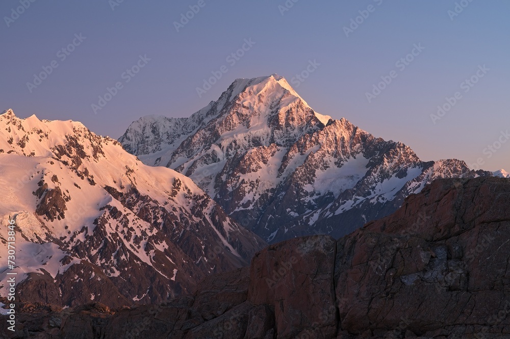 Sunrise with rocky mountain covered with snow and ice. Mount Cook, New Zealand.