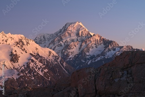 Sunrise with rocky mountain covered with snow and ice. Mount Cook, New Zealand.