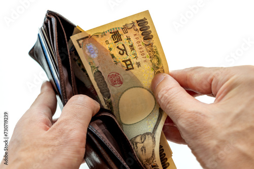 財布から一万円札を取り出す photo