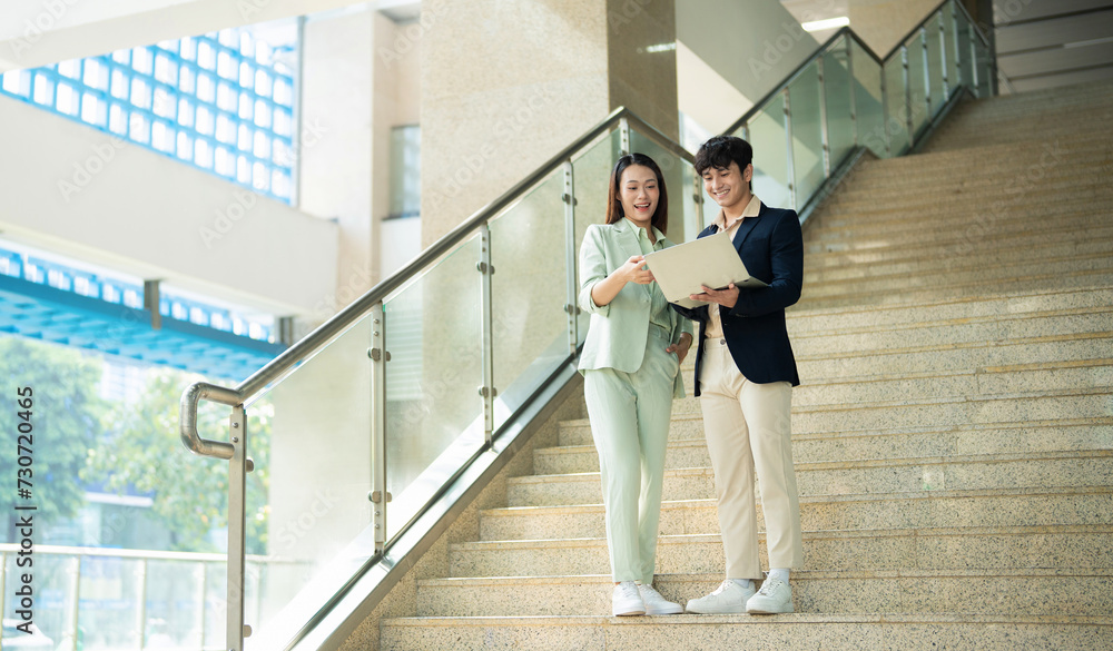 Photo of two young Asian businesspeople Photo of two young Asian businesspeople