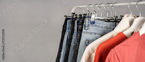 Jeans on a hanger. Casual wear. Modern, youth women's denim trousers. Shopping in the store. photo