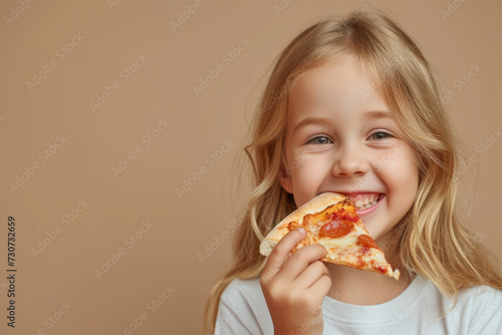 happy little girl eating a piece of pizza on empty beige background