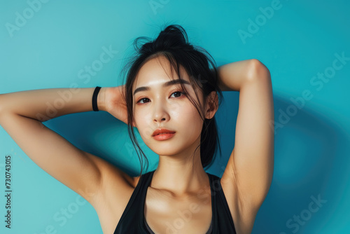 young fitness asian woman on blue background