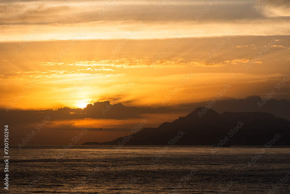 Beautiful, golden sunrise sky over the Moroccan sea coast, near Gibraltar.