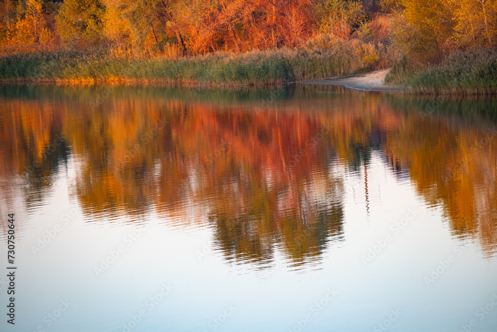 glare and reflections on the water. the sky is reflected in the water. Background of waves, reflections, refractions and abstract diffractions, in the blue, clean and crystalline water. trees are refl glare and reflections on the water. the sky is reflected in the water. Background of waves, reflections, refractions and abstract diffractions, in the blue, clean and crystalline water. trees are refl