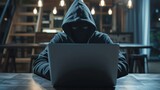 A hacker wearing a hoodie typing something on laptop, hacker on the job