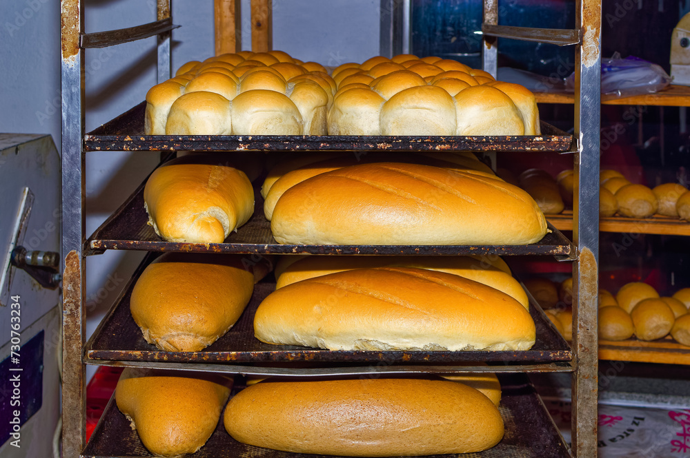 Fresh bread resting on shelves before transportation to the shops.