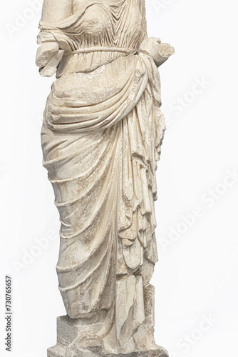 Woman torso in ancient classical dressing, elegant drapery. Fragment of marble statue. Rome period. Selcuk, Turkey. Close up fragment, isolated, white background. Fashion, design, art history concept photo