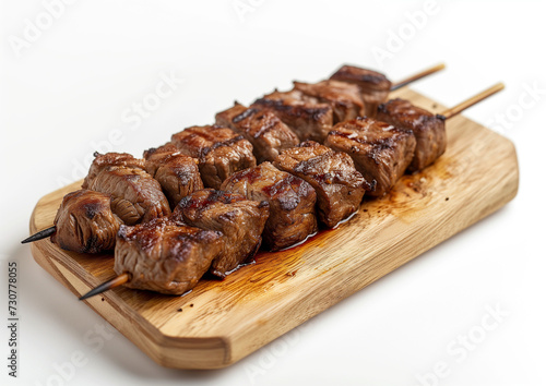Delicious beef skewers, grilled, wood plate or tray. Isolated white background, Brazilian traditional 