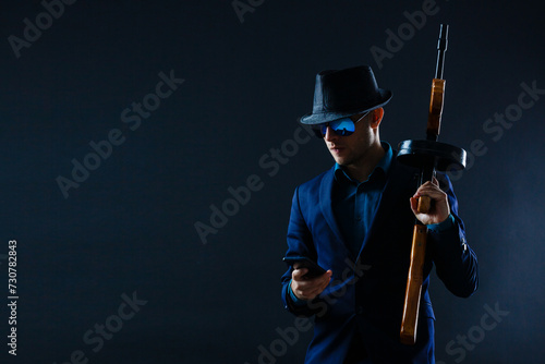 businessman in sunglasses and with a machine gun.