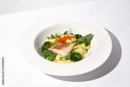 Cod Fillet with Red Caviar and Zucchini and Broccoli Garnish on White, an Elegant Dish for Fine Dining