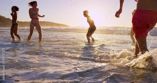 Beach, jump and friends playing in ocean together for fun on travel, vacation or holiday in summer. Splash, water and group of young people in sea waves outdoor on tropical coast for getaway