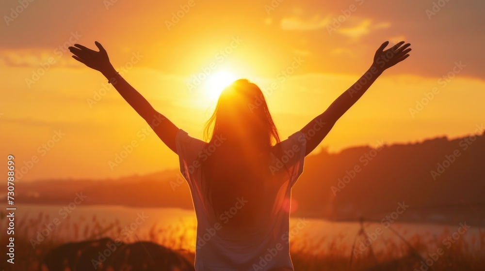 Fototapeta premium Woman Embracing the Sunset with Open Arms