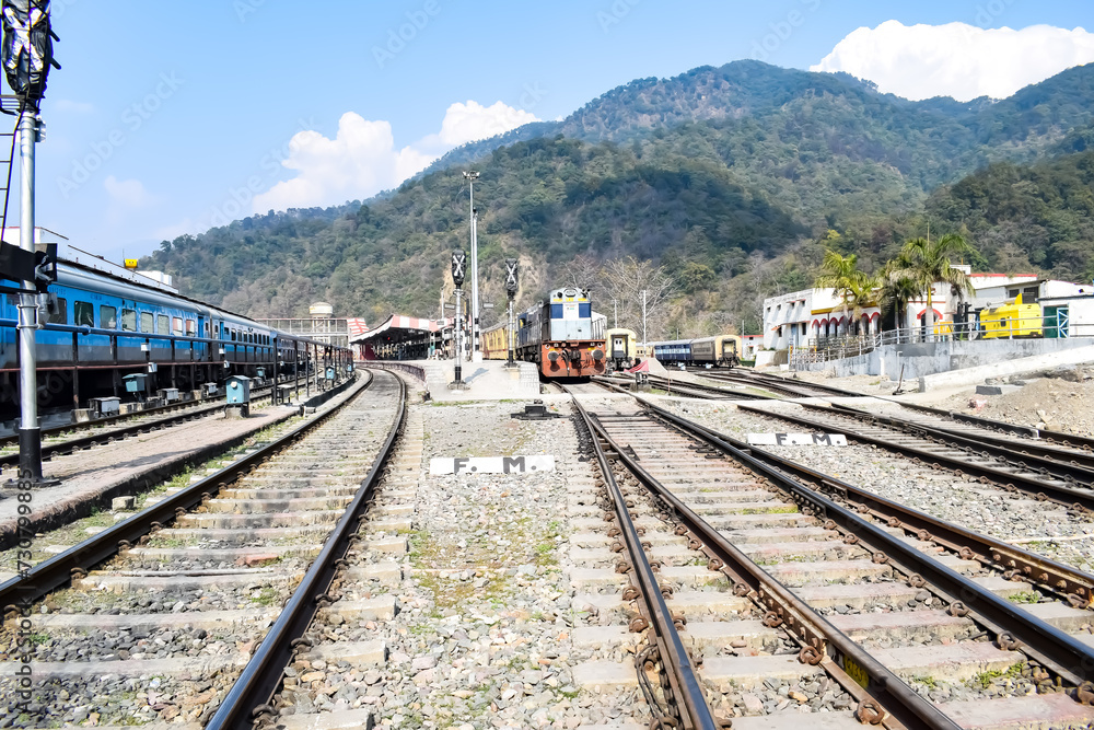 View of train Railway Tracks from the middle during daytime at Kathgodam railway station in India, Toy train track view, Indian Railway junction, Heavy industry View of train Railway Tracks from the middle during daytime at Kathgodam railway station in India, Toy train track view, Indian Railway junction, Heavy industry