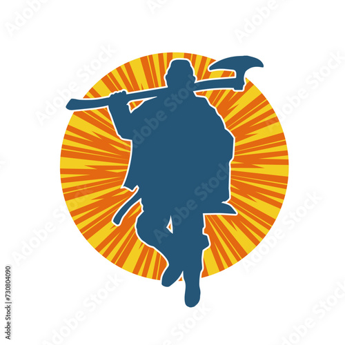 Silhouette of a male warrior carrying broad bladed war axe. Silhouette of a viking warrior with bearded axe weapon in action pose.
