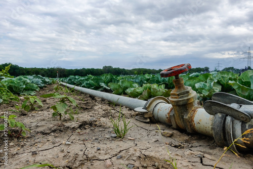 dried out soil in a field with a turned off tap problems with the harvest due to global warming