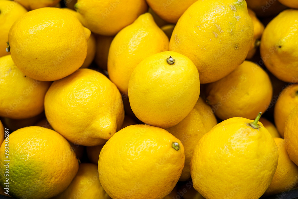 Ripe Yellow Lemons Close-up Background Or Texture. Lemon Harvest, Many Yellow Lemons in the store